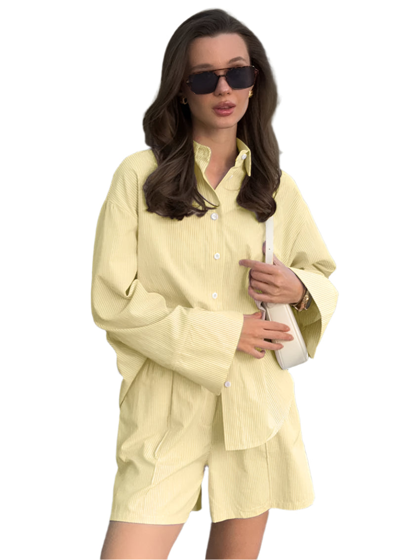 Woman wearing a light yellow outfit with sunglasses and a handbag, standing outdoors.